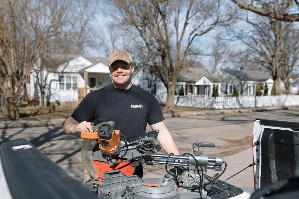 Adam Ginn with a miter saw set up in a truck bed