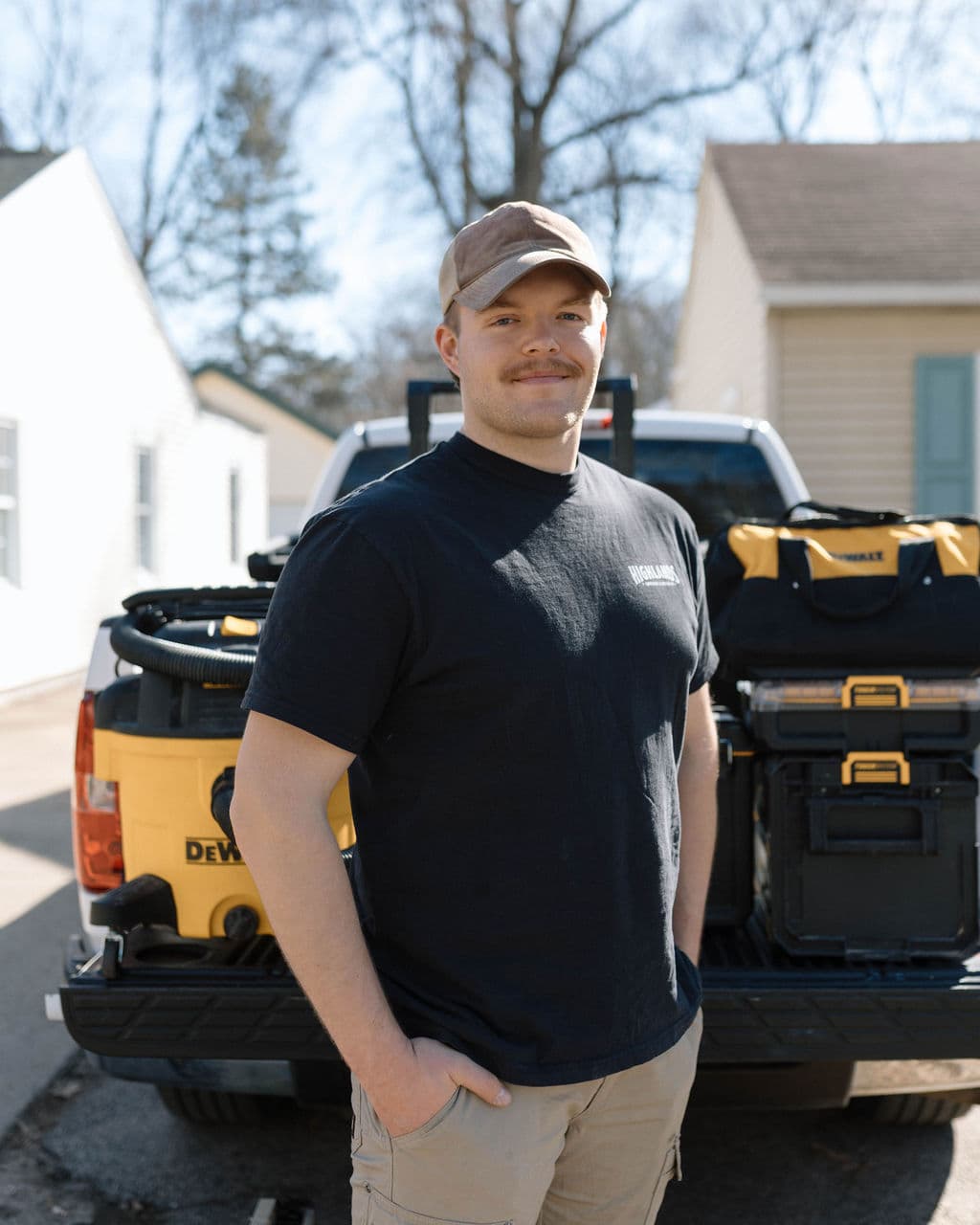 Adam Ginn standing in front of a truck loaded with tools