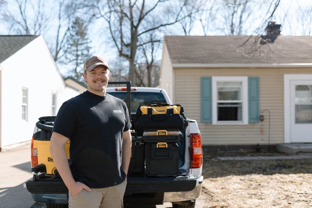 Adam Ginn beside his loaded carpentry work truck
