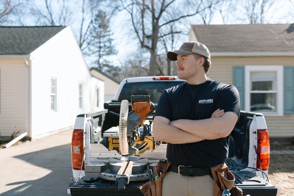 Adam Ginn beside a miter saw in the back of his work truck