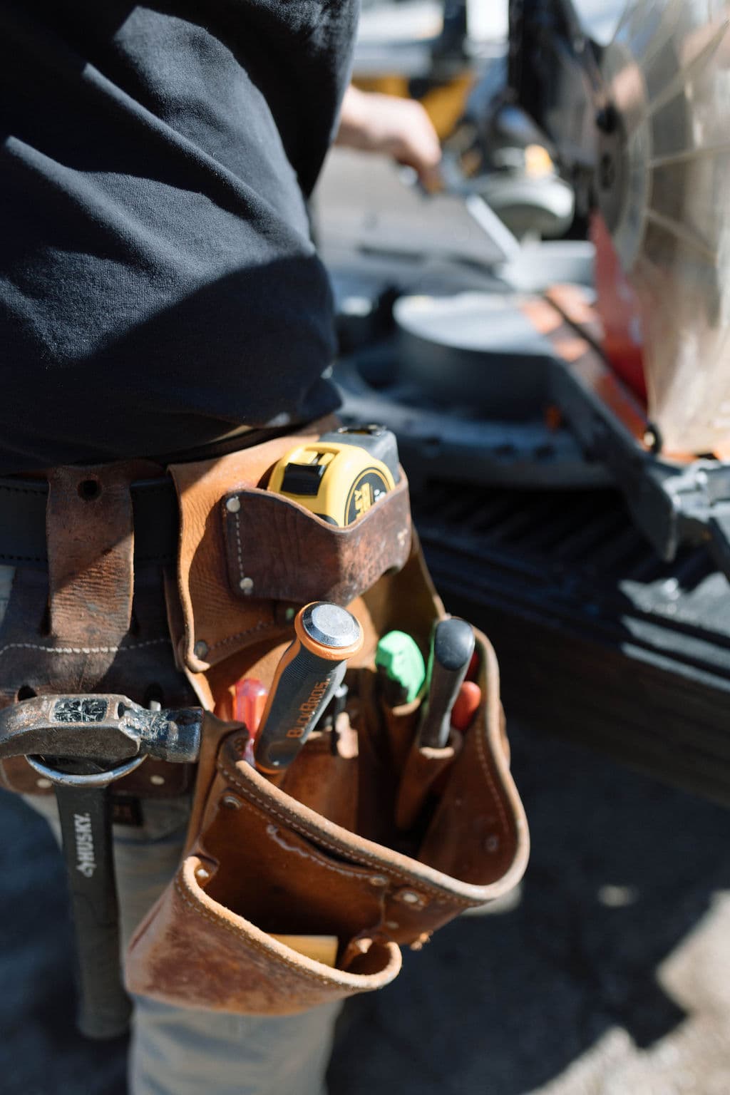 Leather carpenter tool belt holding measuring and hand tools